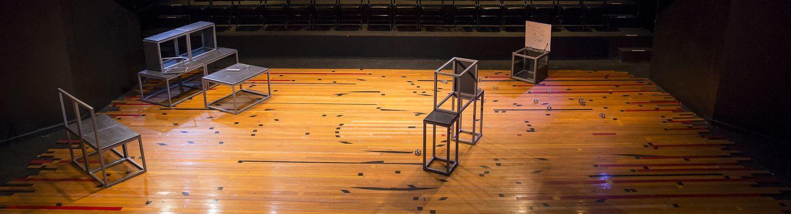 Open, metal blocks on a stage.