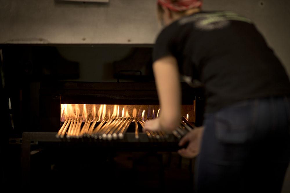 An image of a student placing glass in oven